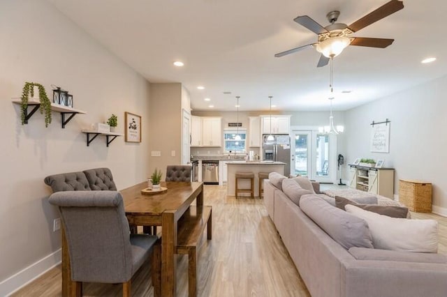 living room with light hardwood / wood-style flooring and ceiling fan