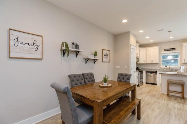 dining room with light wood-type flooring