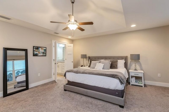 carpeted bedroom with ceiling fan and ensuite bathroom