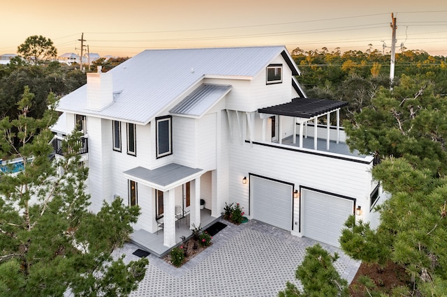 view of front of home featuring a balcony and a garage