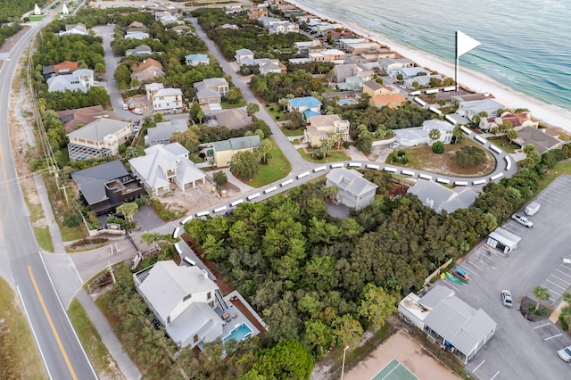 bird's eye view featuring a water view and a beach view