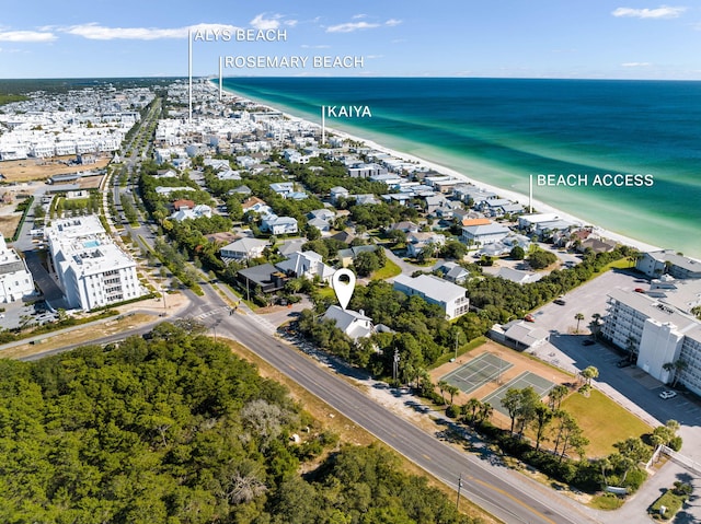 birds eye view of property featuring a water view and a beach view