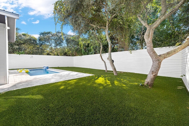 view of yard with a fenced in pool