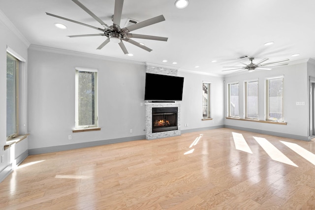 unfurnished living room with crown molding and a healthy amount of sunlight