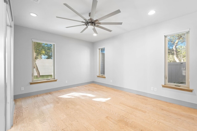 spare room with ceiling fan, light hardwood / wood-style flooring, and plenty of natural light