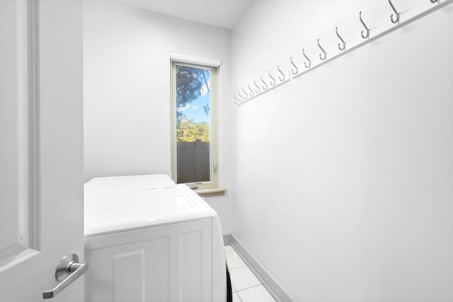 laundry area featuring washer and dryer and light tile patterned flooring