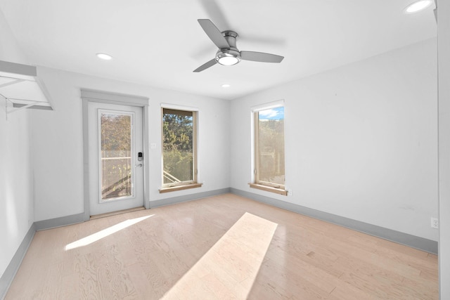 empty room with light wood-type flooring and ceiling fan