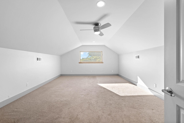 bonus room featuring ceiling fan, lofted ceiling, and light colored carpet