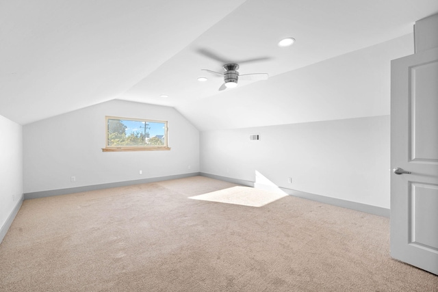 bonus room featuring lofted ceiling, light carpet, and ceiling fan