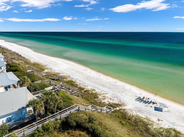 bird's eye view featuring a water view and a beach view