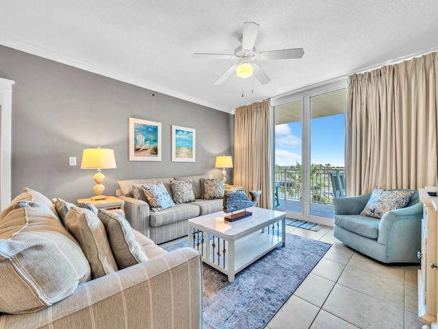living room featuring ceiling fan, a textured ceiling, and light tile patterned floors