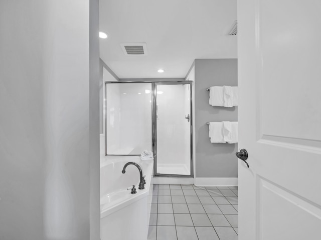 bathroom with plus walk in shower and tile patterned flooring