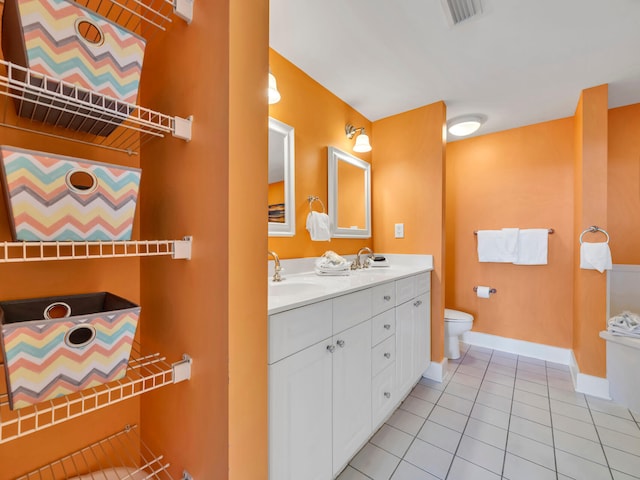 bathroom featuring toilet, vanity, and tile patterned floors