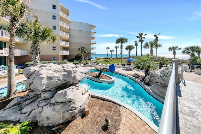 view of pool with a water view