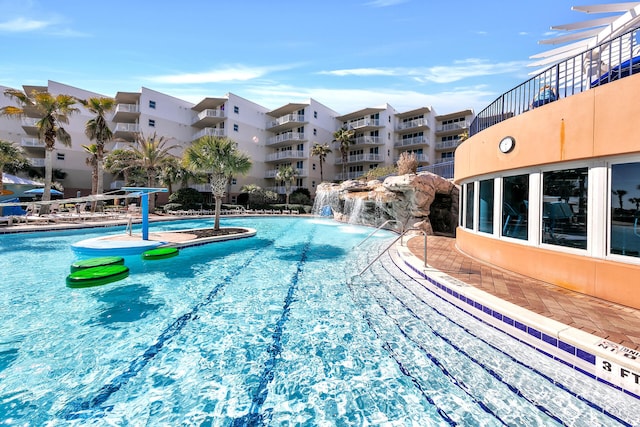view of swimming pool with pool water feature