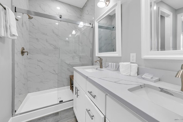 bathroom featuring vanity, wood-type flooring, and an enclosed shower