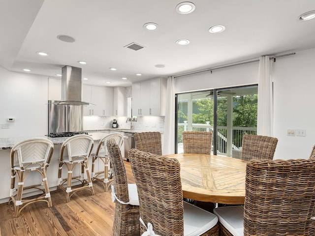 dining room with light hardwood / wood-style floors and sink