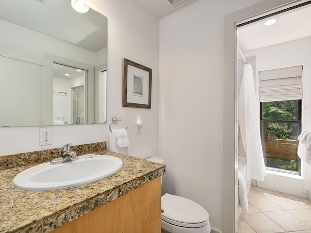 bathroom with vanity, tile patterned flooring, and toilet