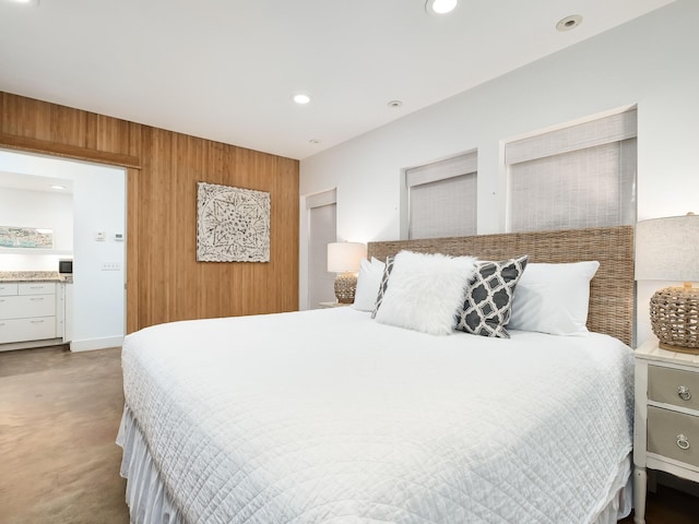 bedroom featuring wood walls