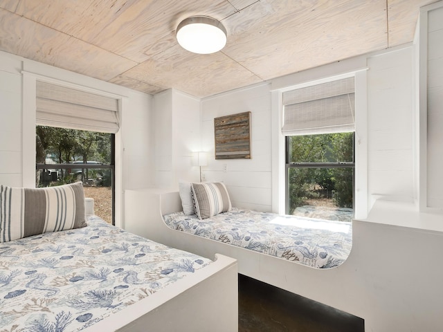 bedroom featuring wood ceiling and multiple windows