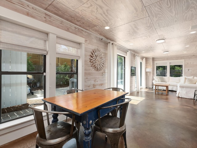 dining area featuring wood walls