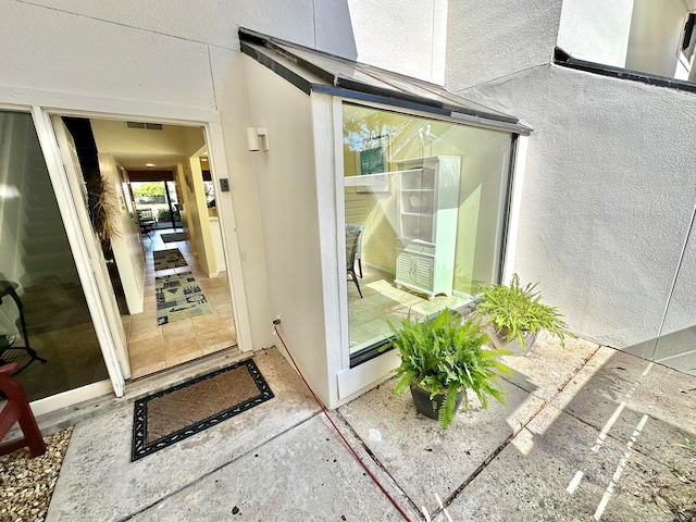 entrance to property with a patio area