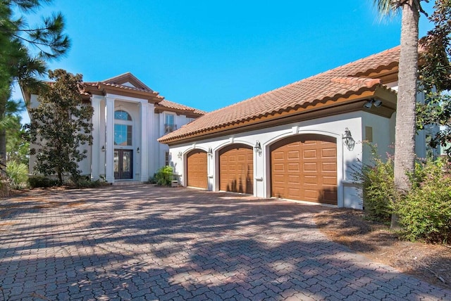 mediterranean / spanish-style home featuring a garage