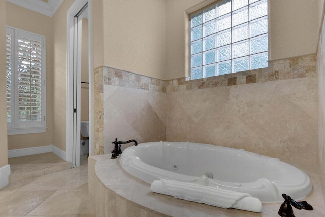 bathroom featuring toilet, crown molding, a healthy amount of sunlight, and tiled bath