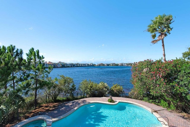 view of swimming pool with a water view