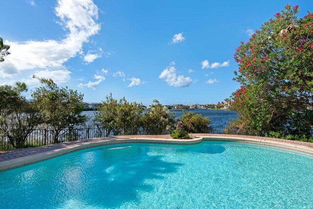 view of pool with a water view