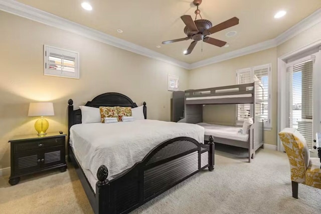 carpeted bedroom with ceiling fan and ornamental molding