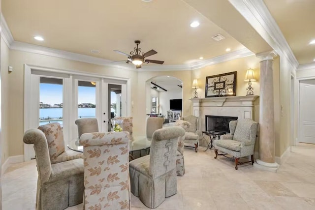 living room featuring crown molding, ornate columns, and ceiling fan