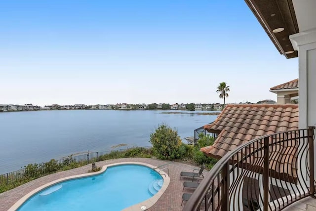 view of swimming pool with a water view