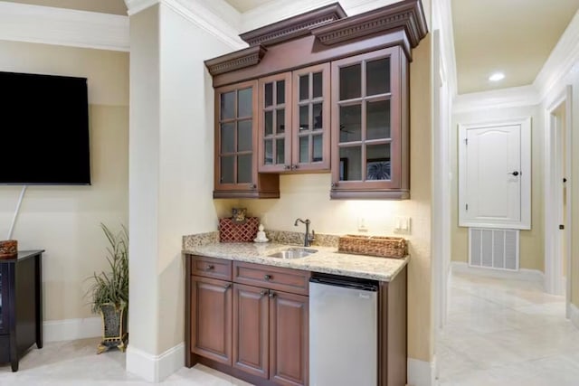 bar featuring crown molding, sink, stainless steel dishwasher, and light stone counters