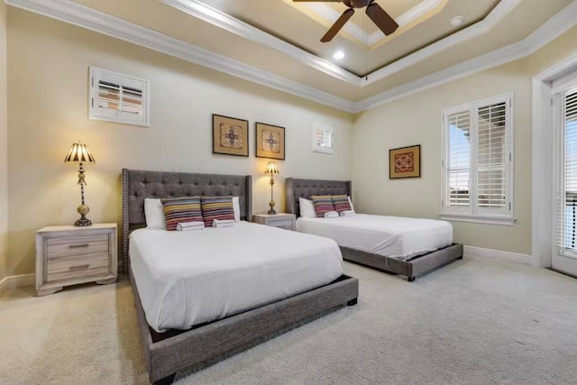 bedroom featuring ceiling fan, a raised ceiling, ornamental molding, and carpet floors