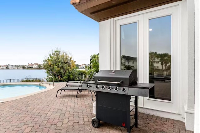 view of patio / terrace featuring a water view and grilling area