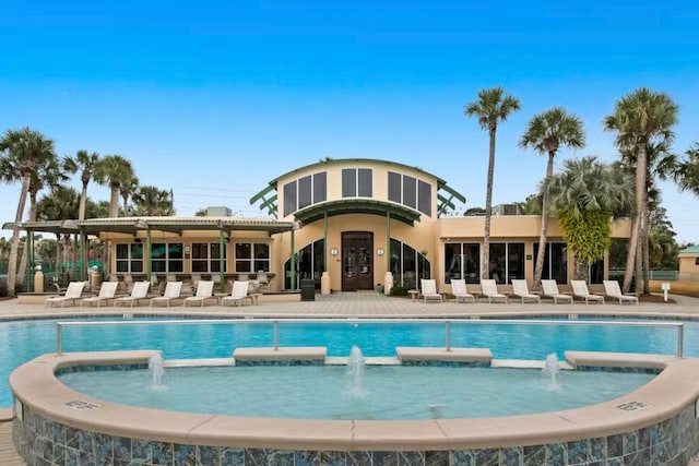 view of pool featuring pool water feature, a patio area, and a jacuzzi