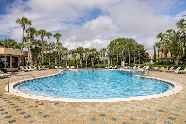 view of pool featuring a hot tub and a patio