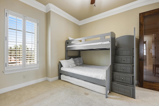 bedroom featuring ceiling fan, crown molding, multiple windows, and light colored carpet