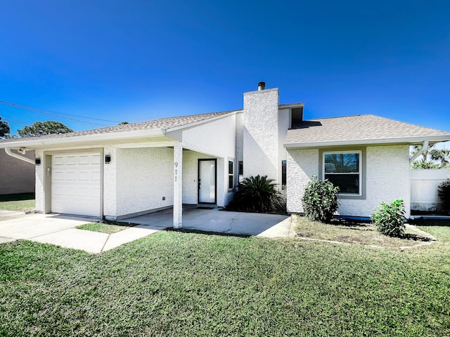 single story home featuring a front yard and a garage