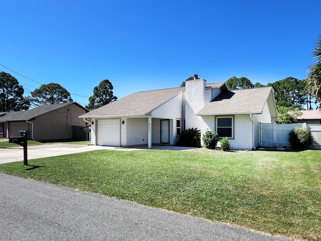 ranch-style home with a garage and a front lawn