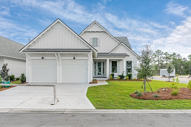 view of front of property featuring a garage and a front yard