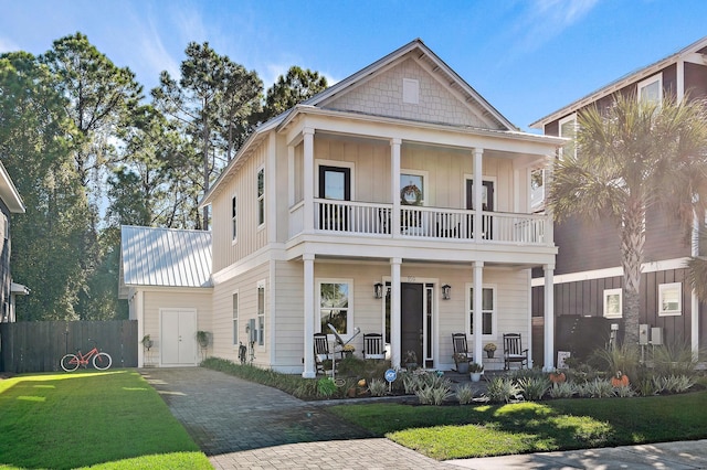 view of front of home with a porch, a front yard, and a balcony