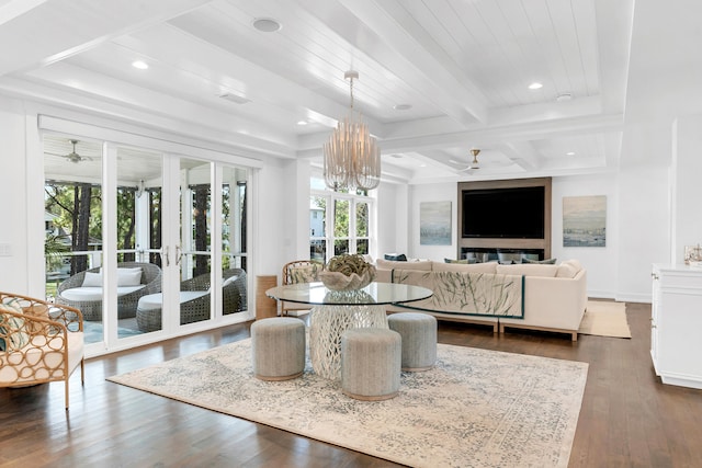 living room with ceiling fan with notable chandelier, beam ceiling, dark hardwood / wood-style flooring, and coffered ceiling