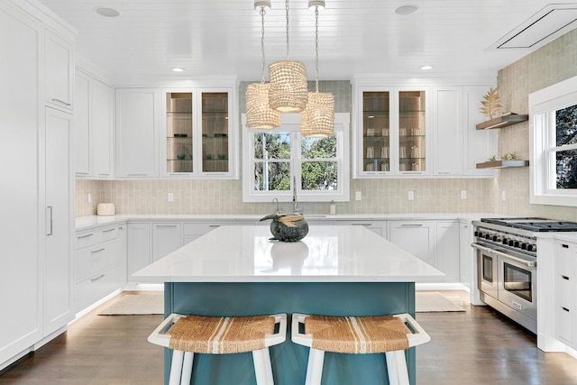 kitchen featuring a healthy amount of sunlight, white cabinetry, and double oven range