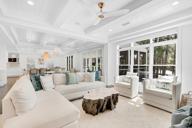 living room featuring ceiling fan with notable chandelier, beamed ceiling, coffered ceiling, and light hardwood / wood-style flooring