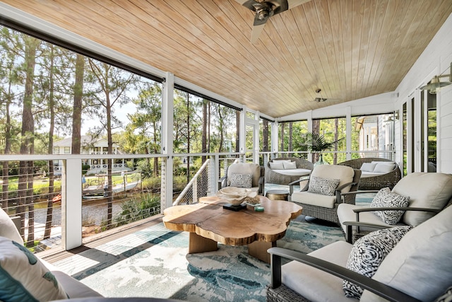 sunroom featuring ceiling fan, vaulted ceiling, and wooden ceiling