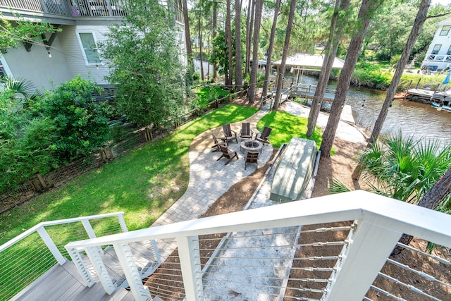 view of yard featuring a water view, a patio, and a fire pit