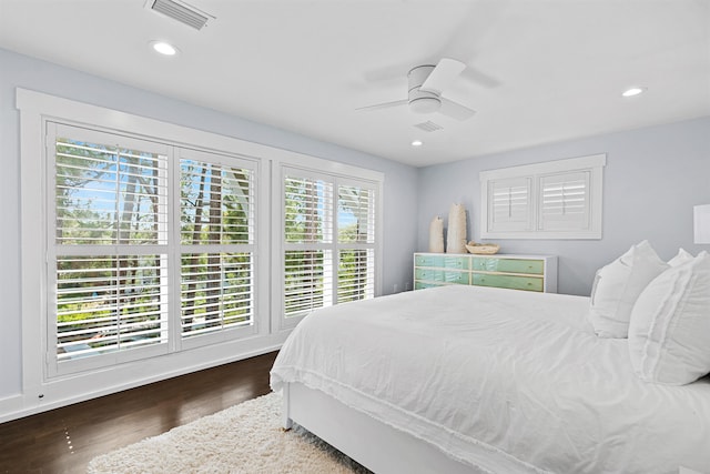 bedroom with ceiling fan and dark hardwood / wood-style floors