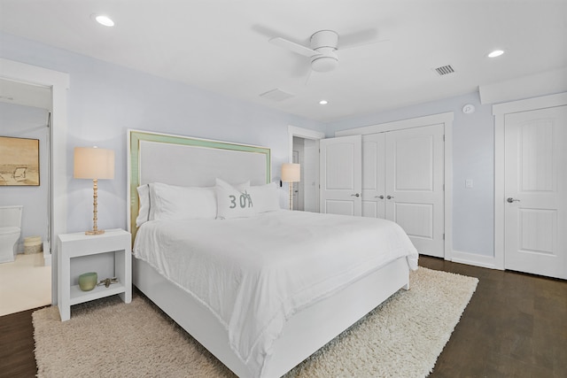 bedroom with ceiling fan, ensuite bath, a closet, and dark hardwood / wood-style floors